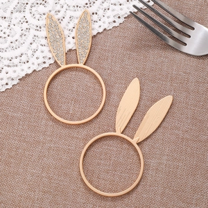 Set of two gold bunny ear napkin rings with rhinestones and textured metal finish