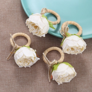 Set of four handmade white rose napkin rings with woven hemp rope and green leaves