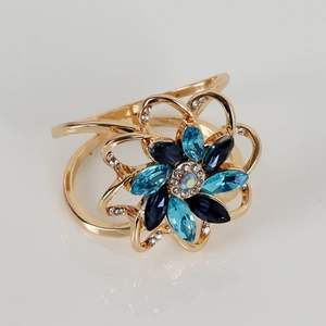 Floral crystal napkin ring with blue marquise gems and gold plated alloy base