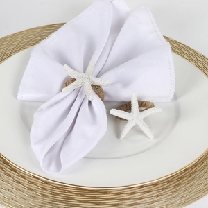 Textured white starfish napkin ring with natural jute rope on a ceramic dining plate