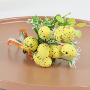 Detail shot of yellow speckled Easter eggs with white flowers and ribbon on wooden ring