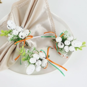 Easter spotted egg napkin ring with green leaves and festive tricolor ribbon decoration