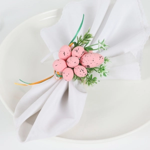 Detail of pink spotted Easter egg napkin ring with faux greenery and ribbons