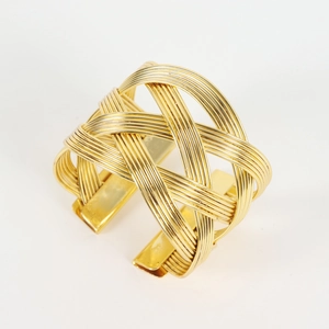 Irregular woven gold metal napkin ring with a minimalist mesh texture for table decor