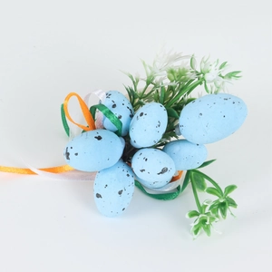 Macro detail of Easter napkin ring featuring light blue speckled eggs and floral ribbon