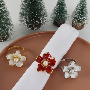Floral pearl napkin rings with rhinestones on a tray for elegant holiday table decor