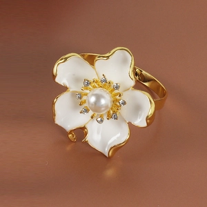 Floral napkin ring with white enamel petals, gold edges and center pearl for table decor