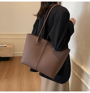 Deep brown lychee leather tote bag shown on model for daily commuting style