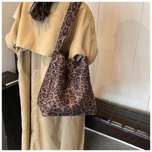 Detail of leopard print tote bag showing thick fabric texture and wide shoulder strap