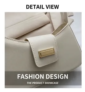 Detail view of cream faux leather handbag featuring a gold buckle and fine stitching