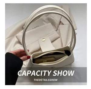 Top view of cream white shoulder bag showing spacious interior with zipper compartment