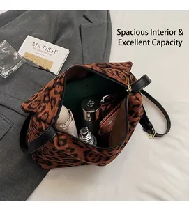 Interno spazioso della borsa tote leopardata con ombrello, trucco e oggetti vari