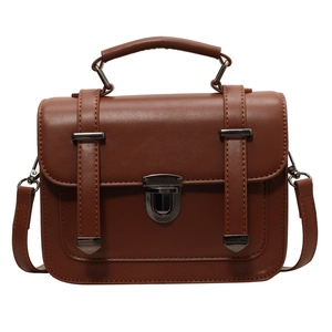 Vintage brown leather crossbody satchel bag with metallic buckle and top handle