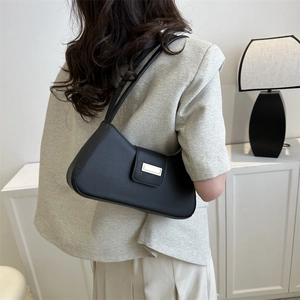 Chic black minimalist baguette shoulder bag with gold buckle and slim double straps