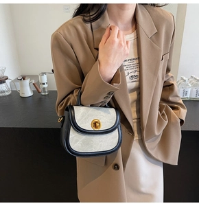 Detail of marble texture faux leather small crossbody bag with gold twist lock