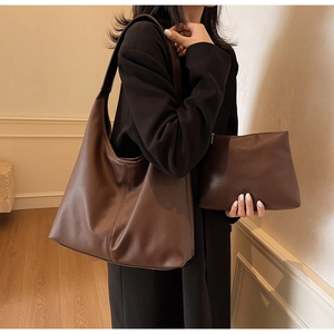 Detail of dark brown lychee texture leather hobo bag and matching zip pouch set