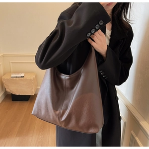 Detail of soft dark brown pebble leather on a large Hobo shoulder tote bag for work