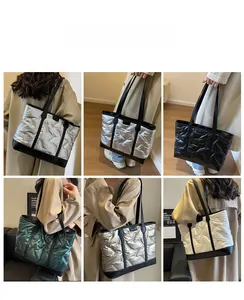 Close-up of quilted padded tote bags in metallic silver, black, green and beige finishes