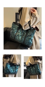 Detail of green quilted tote bag with glossy nylon finish and black leather trim accents