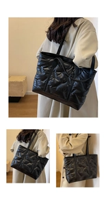 Detail of black quilted puffer tote bag showing V-shaped texture and large capacity