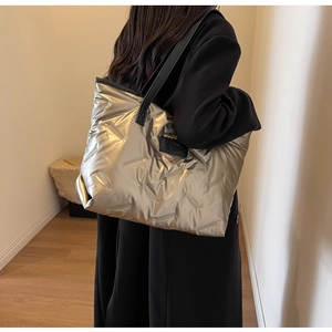 Vue détaillée du tissu matelassé métallisé champagne et des bandoulières du sac cabas