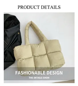Detailed view of quilted beige puffer tote bag with soft padded handle and square pattern