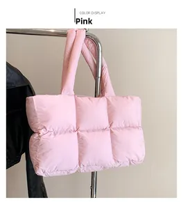 Detailed close-up of a pink quilted puffer tote bag with soft padded handle and stitch finish