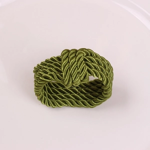 Macro detail of dark blue braided cord napkin ring with textured spiral rope weave