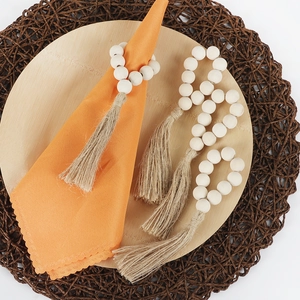 Rustic wood bead napkin rings with natural jute tassels for elegant boho table decor