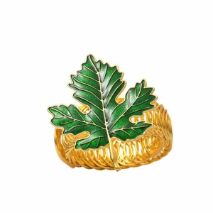 Detail of green enamel leaf curtain tieback with golden woven spring metal ring