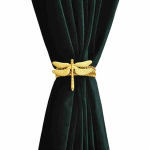Golden dragonfly curtain tieback with elastic metal spring on dark green fabric