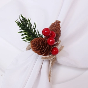 Rustic Christmas napkin ring with pine cones red berries and green pine needles on white linen