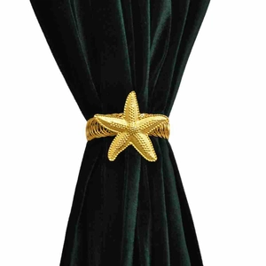 Golden starfish metal spring curtain tieback clip on elegant dark green velvet fabric