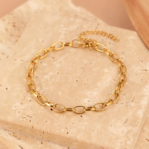 Minimalist gold oval link chain bracelet with adjustable lobster clasp on marble