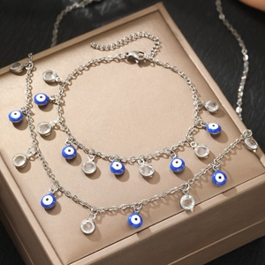 Silver stainless steel Evil Eye bracelet with blue beads and crystals on display box