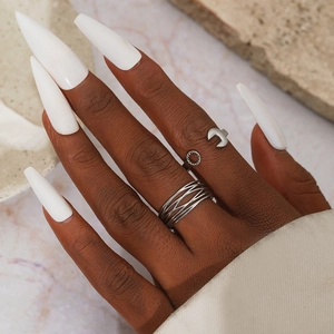 Minimalist stainless steel geometric cross ring set with wrench and gear industrial design