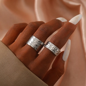 Set of silver stainless steel rings with abstract textures and hammered finish style