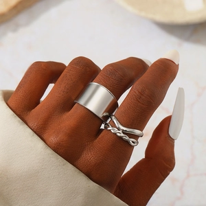 Silver stainless steel wide band and braided ring set for women on model's hand