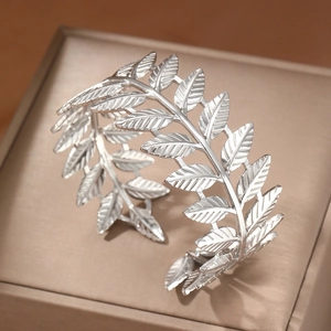 Elegant silver laurel leaf open arm cuff with detailed leaf texture on jewelry box