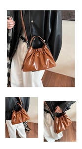 Detail of glossy brown leather cloud bag featuring pleated design and metal hardware