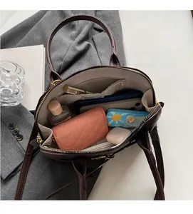 Interior view showing the large capacity and functional compartments of this brown leather bag