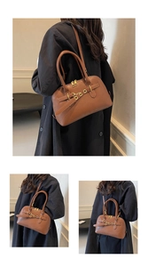 Macro detail of brown pebbled leather texture and gold hardware on this chic handbag