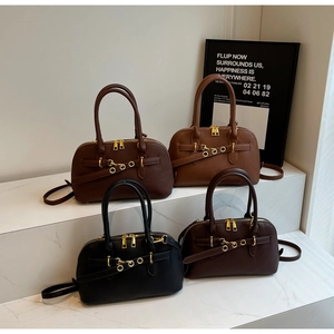 Litchi pattern Boston bags in four colors displayed on marble steps with gold zippers
