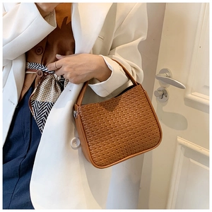 Brown woven texture handbag worn over the shoulder showing actual size and material detail