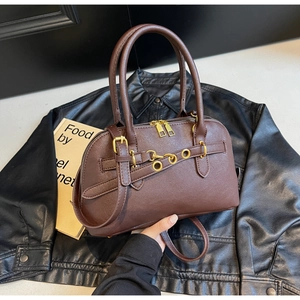 Detailed view of dark brown leather Boston bag with vintage gold hardware and dual zippers