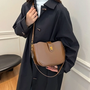 Vintage dark brown gloss saddle bag with gold swivel lock and adjustable shoulder strap