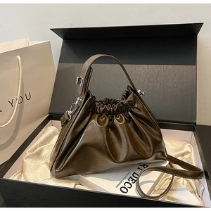 Detail of dark olive green cloud bag in a gift box with silk lining and chain strap