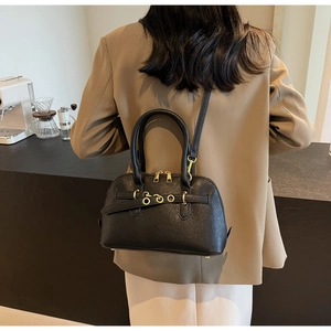 Chic black pebbled leather crossbody bag with dual gold zippers and elegant metal accents