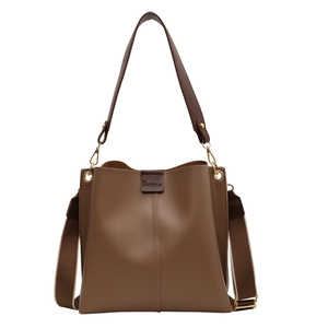Vintage brown leather bucket bag with adjustable wide woven strap and golden hardware