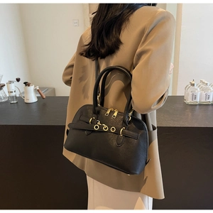 Close-up of a black lychee-textured Boston bag with gold hardware and double zippers